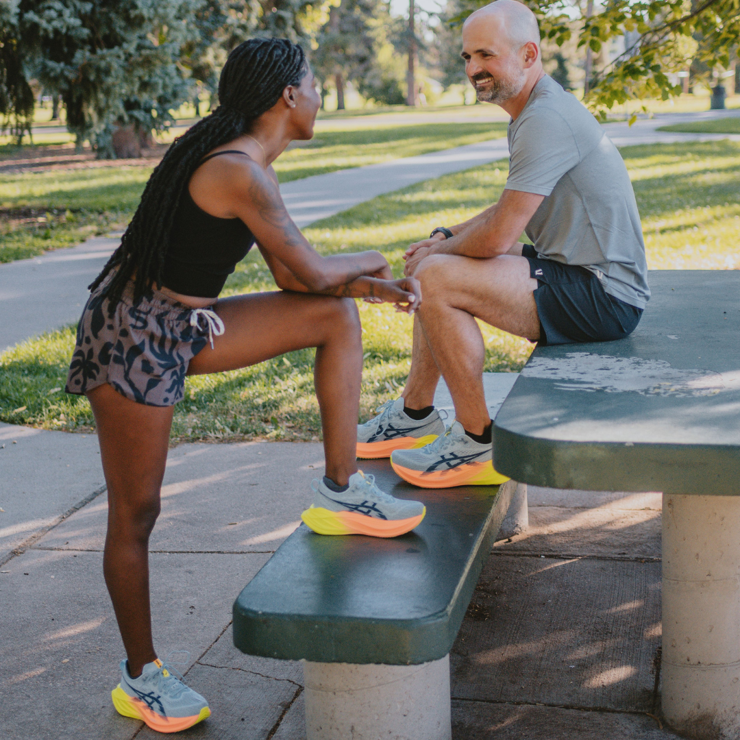 Two people wearing Asics Superblast shoes and Vuori apparel