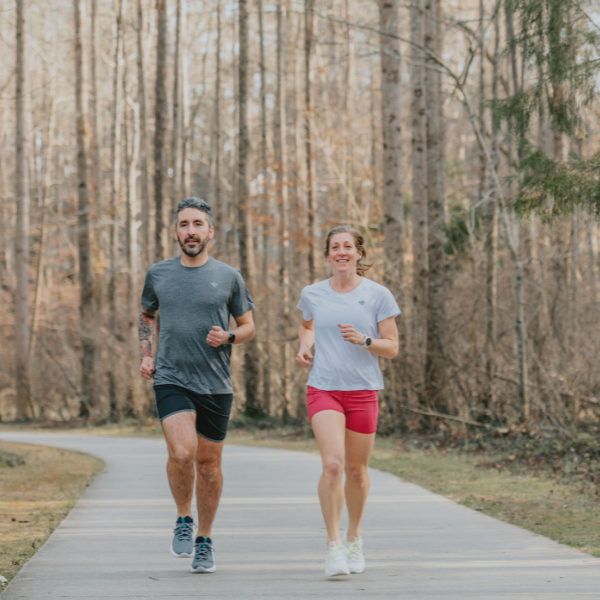 Two people running on a path